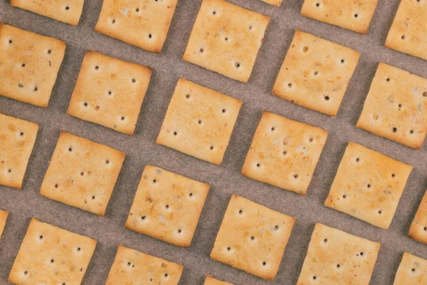 Spicy Square Crackers Parchment Paper Salty Crackers Closeup Macro Shot — Stock Photo, Image