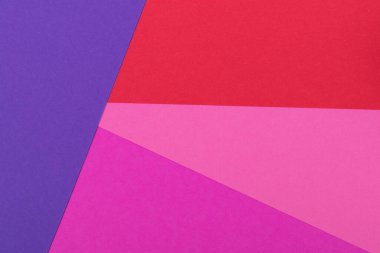Farklı renklerde bir kağıdın çok renkli arkaplanı. Pembe, kırmızı ve mor renklerin karışımı. Geometrik arkaplan.