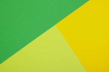 Farklı renklerde bir kağıdın çok renkli arkaplanı. Sarı, yeşil ve limon rengi karışımı. Geometrik arkaplan.