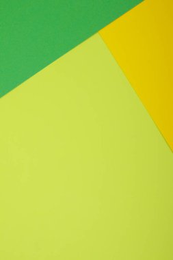 Farklı renklerde bir kağıdın çok renkli arkaplanı. Sarı, yeşil ve limon rengi karışımı. Geometrik arkaplan.