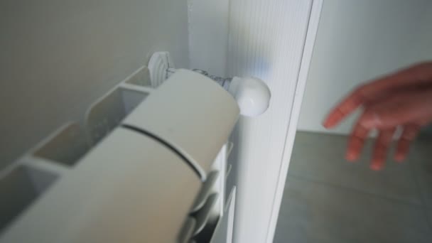 家庭でラジエータヒーターをオンにするためにサーモスタットを調整する女性の手 — ストック動画