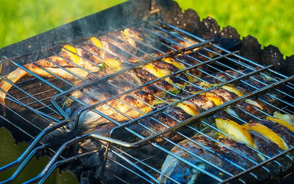 Dorado with lemon and spices is cooked on the fire.
