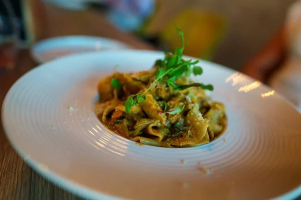 stock image Italian pasta with parmesan in restaurant.