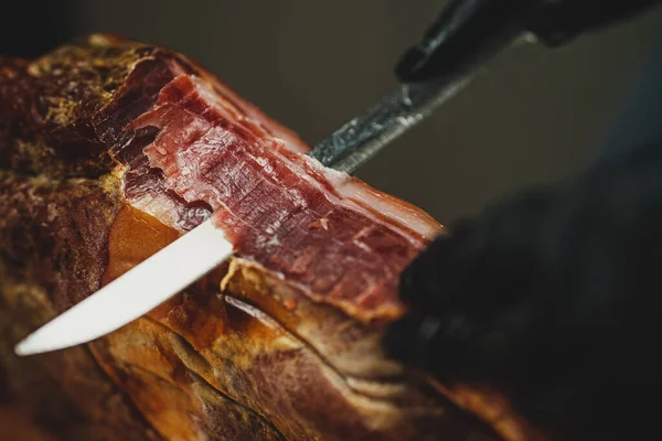 stock image Chef cutting dry-cured spanish ham Jamon.