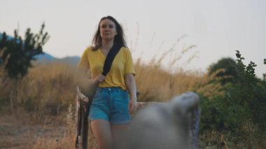 Woman tourist with backpack visits the nature reserve park.