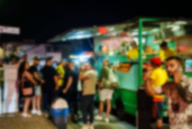 Street food truck late at night. Blurred image.