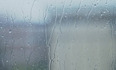 Heavy rain outside the window. Bad weather.