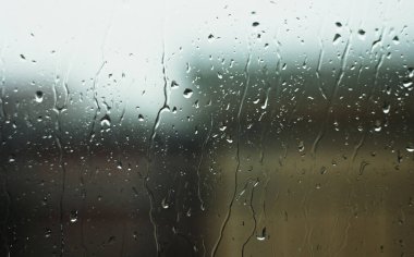 Heavy rain outside the window. Bad weather.