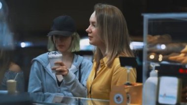 Mom and her daughter order food in street truck.