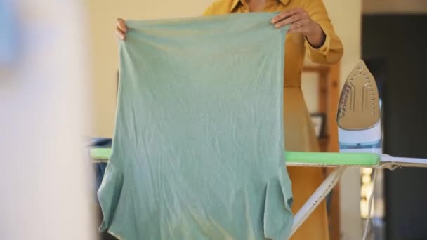 Woman Yellow Dress Ironing Clothes — Stockvideo