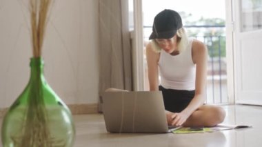 Teenage girl doing her homework with laptop.
