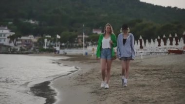 Family walking and talking on the beach.