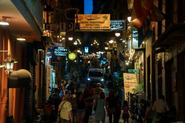 Naples, Italy - 11.06.2022: Crowdy night street in the old town.