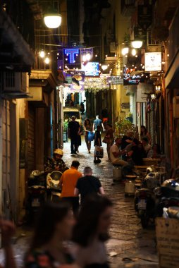 Naples, Italy - 11.06.2022: Crowdy night street in the old town.
