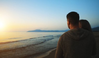 Couple at sunset by the sea.