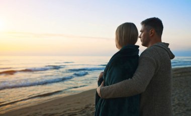 Couple at sunset by the sea.