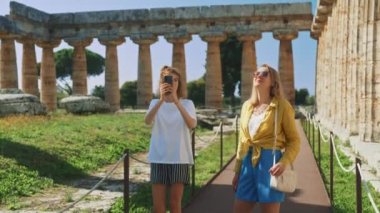 Family of tourists walks around the ancient city.
