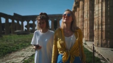 Family of tourists walks around the ancient city.