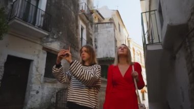 Woman and her daughter exploring old city.