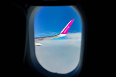 Naples, Italy - 24.06.2022: Wing of Wizz Air, view from window. clipart