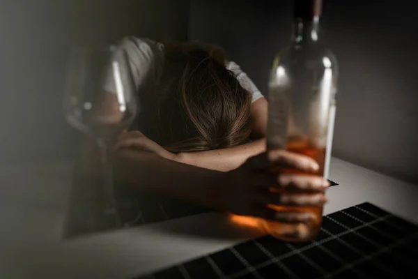 Woman suffering from depression and drinking alcohol.