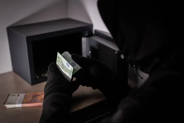 Thief steals money from a steel safe.