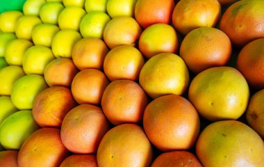 Şehir pazarında olgun ve olgunlaşmamış greyfurtlar.