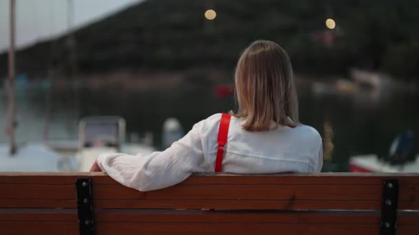 Femme Assise Sur Banc Regarde Baie Avec Des Bateaux — Video