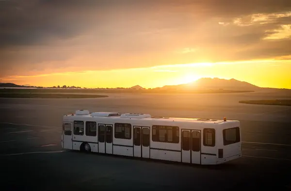 Airport shuttle bus in the airport at sunset.