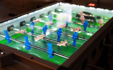 Table football game with white and blue players.