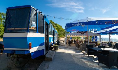 Narva-Joesuu, Estonia - 26.06.2024: Tram converted into a restaurant on the beach. clipart