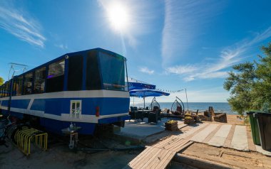 Narva-Joesuu, Estonia - 26.06.2024: Tram converted into a restaurant on the beach. clipart