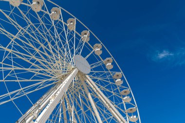 Dönme dolap açık mavi gökyüzüne karşı.