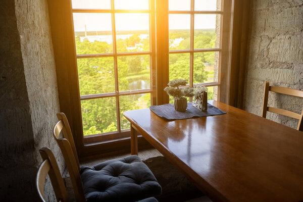 Room with stone walls and sunlight through vintage window.