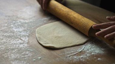 Yuvarlanan hamurla ahşap iğne mutfağı.