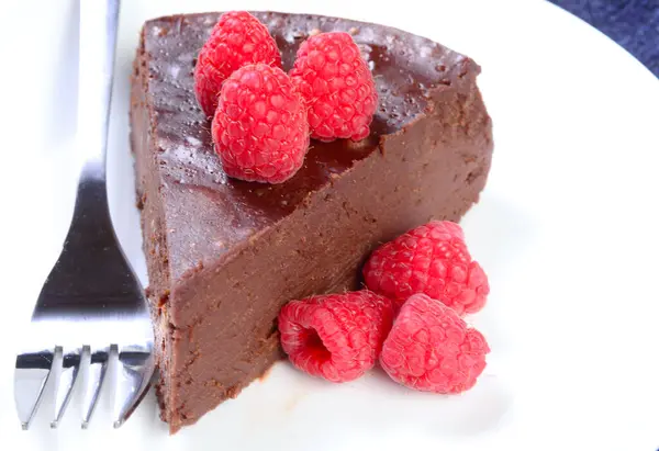 白盘上有覆盆子的无肉巧克力蛋糕 免版税图库照片