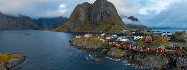 stock image Aerial view of Reine in winter. Top view of Lofoten islands, Norway. Landscape with blue sea, snowy mountains, high rocks and fishermen village with traditional colored buildings.