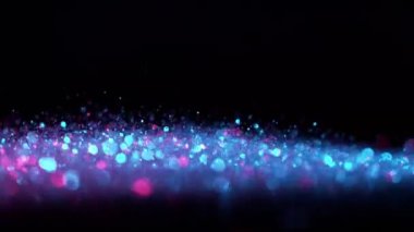 Soyut parlak arka planda neon renklerle parıldayan süper yavaş çekim. Yüksek hızlı kamera, 1000 fps..