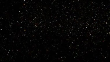 Siyah arkaplanda ışıldayan renkli parçacıkların süper yavaş çekimi. Yüksek hızlı sinema kamerası, 1000 fps..