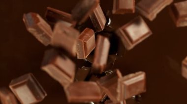 Super Slow Motion of Falling Chocolate Pieces into Melted Chocolate. Filmed with High Speed Cinema Camera, 1000fps.
