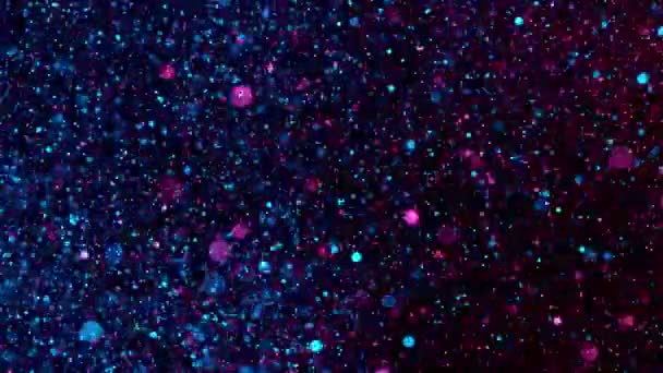 Super Slow Motion Glittering Neon Particles Black Background Shallow Depth — Stock video