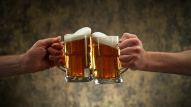 Super slow motion of hitting beer mugs together, cheers concept. Filmed on high speed cinema camera in motion, 1000 fps. Placed on high speed cine bot.