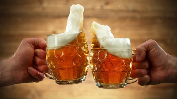 Two Glasses Beer Cheers Gesture Splashing Out Isolated Wooden Background — Stock Photo, Image