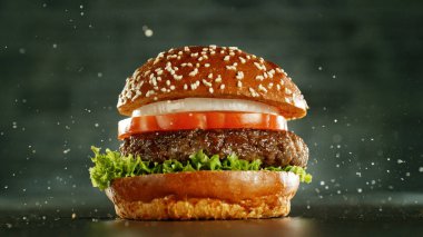 Delicious fresh cheeseburger with old grey background. Fresh american kitchen. clipart