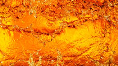 Liquid golden splash texture, abstract beverages background. Whisky, rum, cognac, tea or oil.