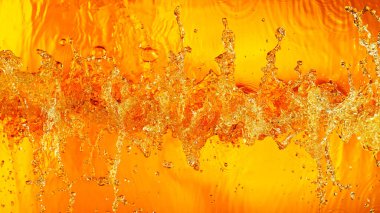 Liquid golden splash texture, abstract beverages background. Whisky, rum, cognac, tea or oil.