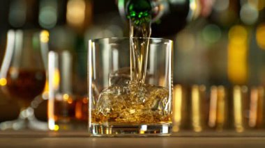 Super Slow Motion of Pouring Whiskey Into Glass. Filmed on High Speed Cinema Camera, 1000 fps. Speed Ramp Effect.