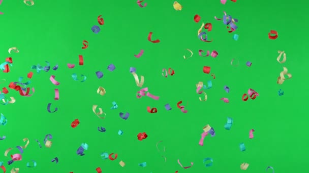 Super Slow Motion Flying Colored Confetti Isolated Green Background Filmed — Stock Video