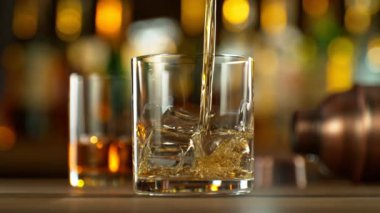 Super Slow Motion of Pouring Whiskey Into Glass. Filmed on High Speed Cinema Camera, 1000 fps. Speed Ramp Effect.