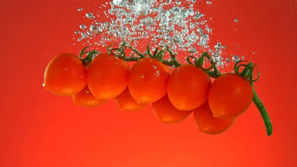 Freeze Motion Fresh Cherry Tomatoes Underwater Isolated Coloured Background — Stock Photo, Image